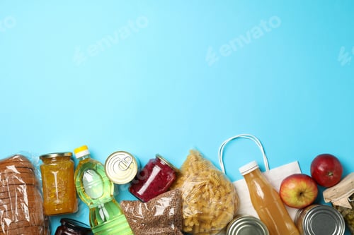 Preview: Different food on blue background, top view. Donation concept