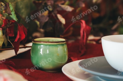 Preview: Tableware on kitchen table with autumn decor close up