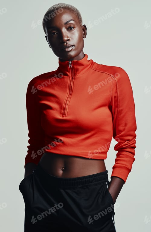 Preview: Studio shot of an attractive young woman in sportswear against a grey background