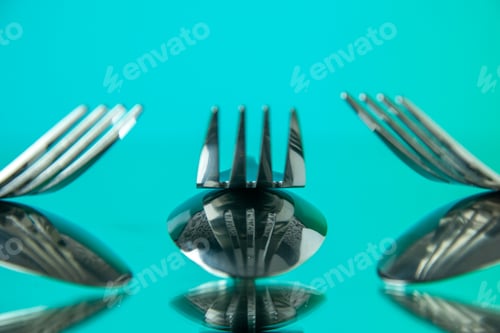 Preview: front close view metal forks on light-blue background cutlery kitchen food color photo table dinner