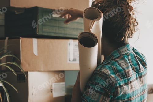 Preview: Woman in indoor relocating moving activity working with stuffs and cardboard carton box packing
