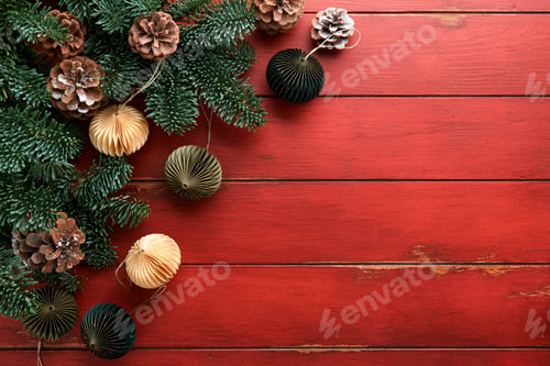 Preview: Christmas composition. Christmas fir tree branches with pine cones and papers rustic balls on wooden