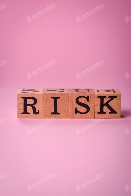 Preview: The inscription Risk made of wooden cubes on a plain background