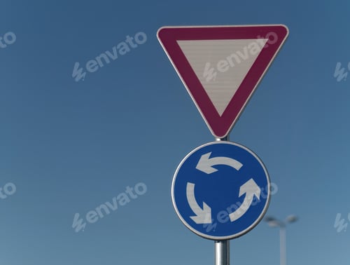 Preview: Close-up shot of a yield and roundabout traffic sign attached on a metal pole