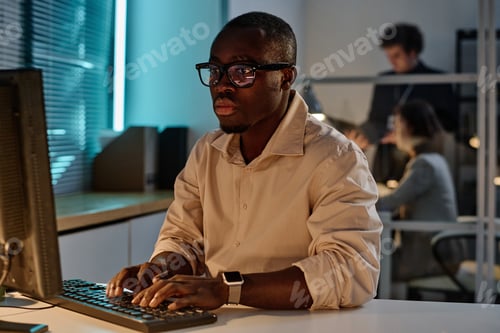 Preview: Programmer concentrating on his online work on computer