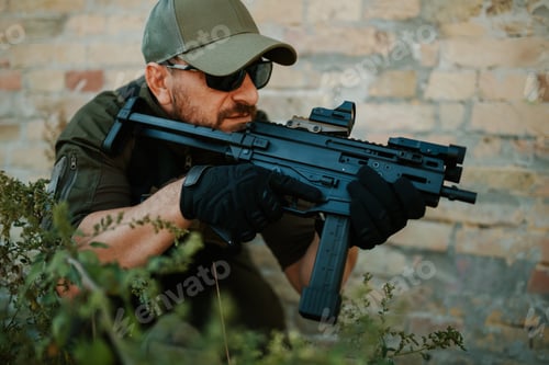 Preview: Soldier aiming with assault rifle near brick wall