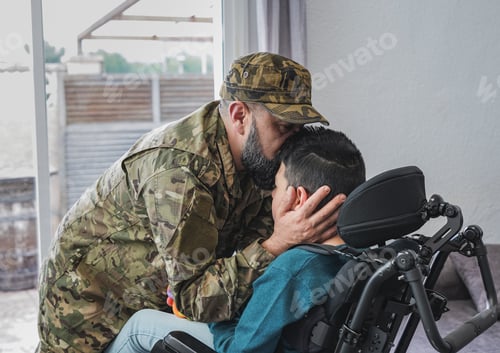 Preview: Military man kissing his son sitting in wheelchair