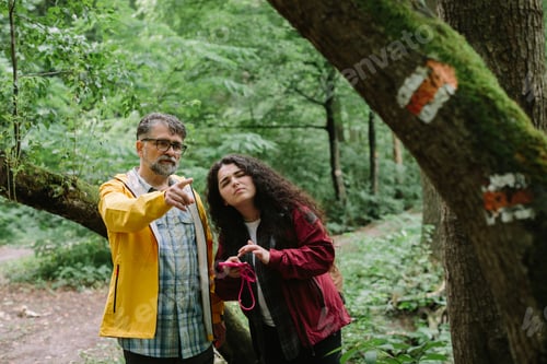 Preview: Father and daughter navigating forest path on a hike