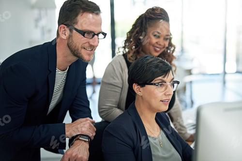 Preview: Take a look at this. Cropped shot of three colleagues working in the office.