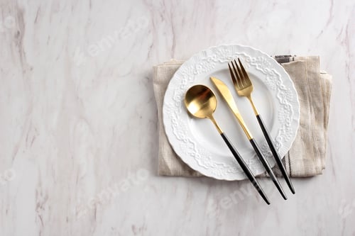 Preview: White Plate with Spoon, Fork, and Knife. Copy Space