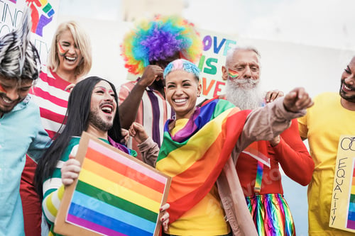 Preview: Gay multi generational people having fun at gay pride parade with banner