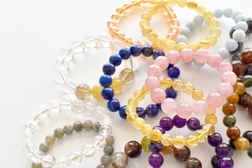 Preview: Collection of crystal gemstones bracelets.