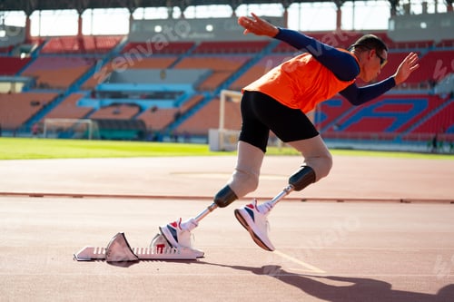Preview: Asian para-athletes with prosthetic blades sprint on a running track at stadium.