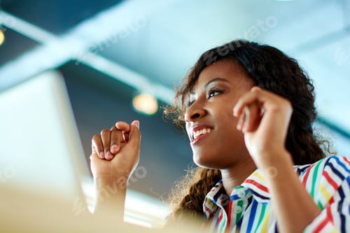 Preview: Candid image of succesful business woman caught in an animated brainstorming meeting