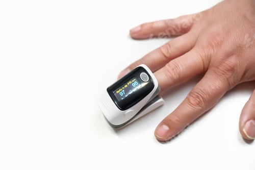 Preview: Pulse oximeter on a finger on a white background