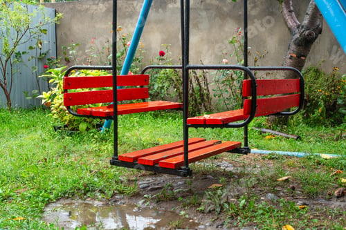 Preview: Empty wet swing in the garden