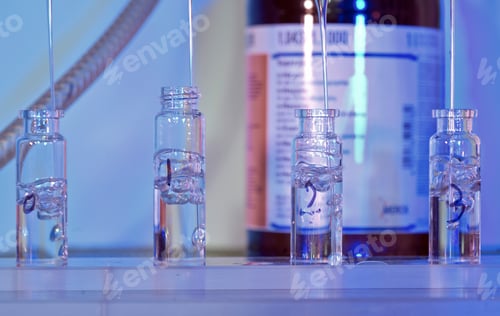Preview: Scientific lab vials bask in a blue glow