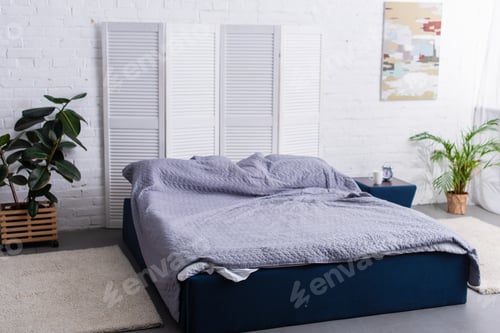 Preview: interior of bedroom with double bed, plants and carpets