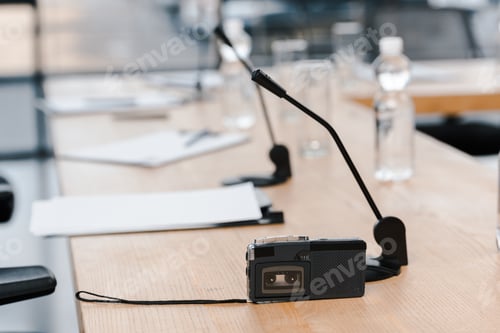 Preview: selective focus of voice recorder near microphones on table