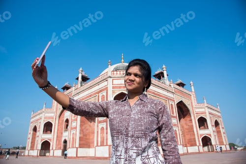 Preview: Young girl taking Photos in front of Humayun's Tomb, Delhi, India.