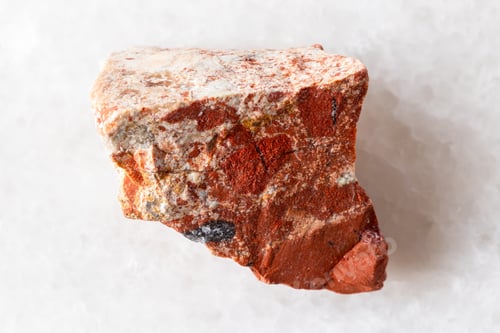 Preview: sample of raw red jasper rock on white marble