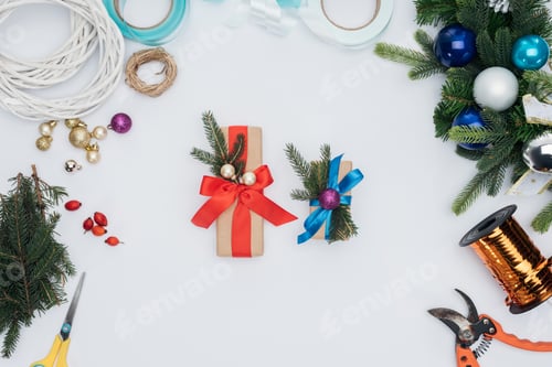 Preview: top view of wrapped christmas gifts, pine tree branches and decorations isolated on white