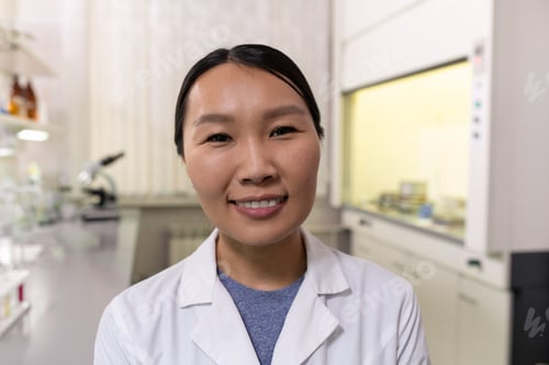 Preview: Young smiling female chemist of Asian ethnicity
