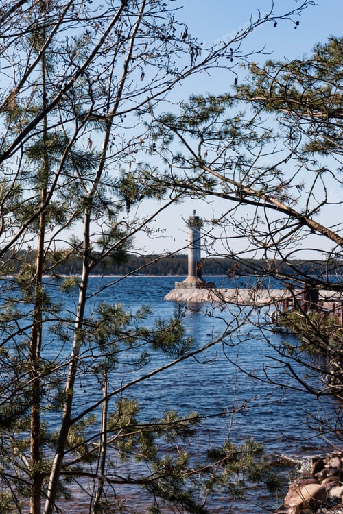 Preview: An abandoned lighthouse surrounded on all sides by blue water