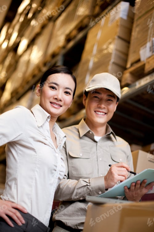 Preview: Chinese businesswoman in a warehouse with worker