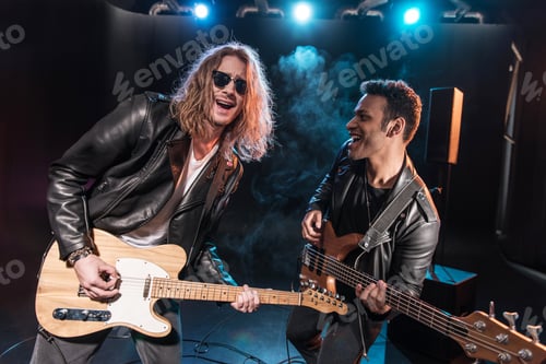 Preview: Electric guitar players performing hard rock music on stage