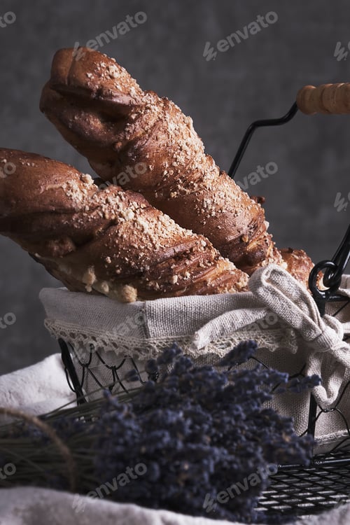 Preview: White bread in a basket and lavender flowers in vintage style.