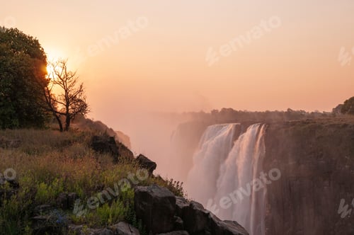 Preview: Sunrise over a serene waterfall
