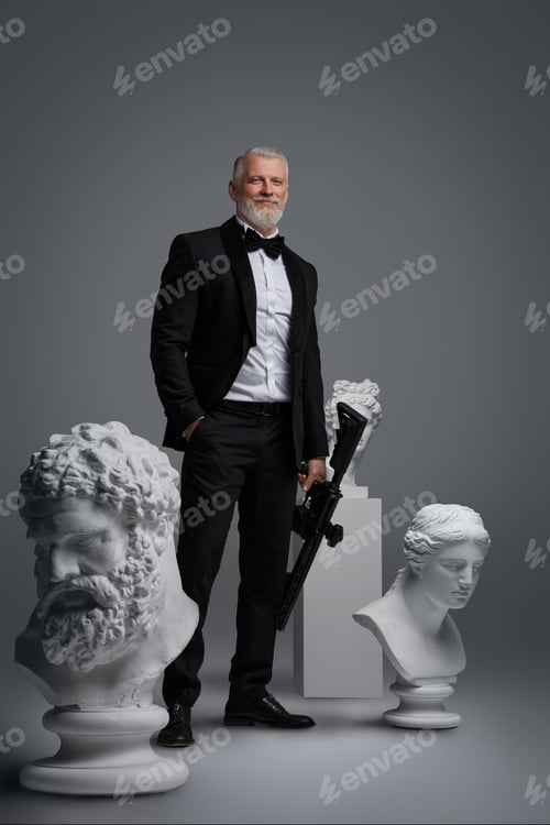 Preview: Stylish older man holding a gun stands surrounded by three ancient sculptures