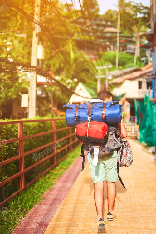 Preview: Seeing the city on foot. Rearview shot of a young backpacker exploring a foreign city on his own.