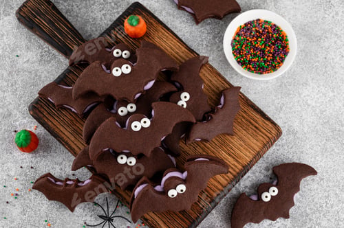 Preview: Halloween cookies. Chocolate sandwich cookies in the shape of a bat with eyes and butter cream