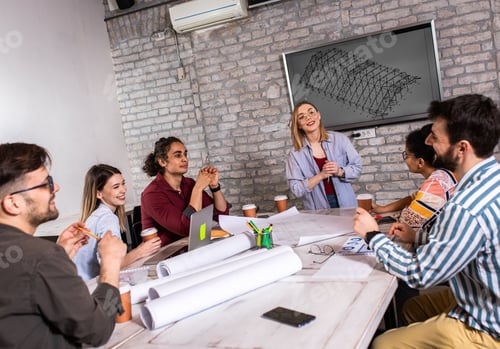 Preview: Group of modern business people in casual wear discussing architectural designs in office.