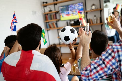 Preview: Diverse friends sports fans watching football match on TV at home. Celebrating shouting excited