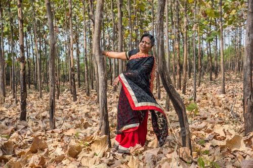 Preview: Happy Indian woman enjoying nature in forest