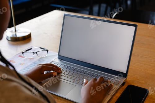 Preview: Plus size african american casual businesswoman using laptop with copy space on screen in office