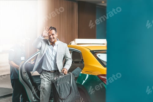 Preview: I'm here. Businessman with headphones is getting out of the car. Copy space on the right side