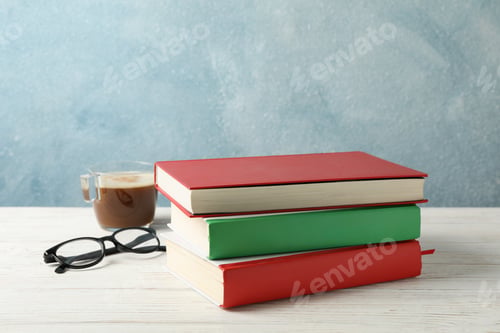 Preview: Books, cup of coffee and glasses on wooden table, space for text