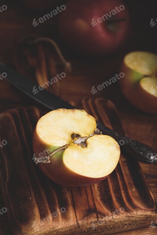 Preview: Halved Red Apple on Cutting Board