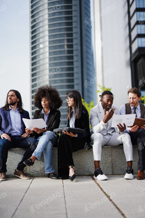 Preview: Multiethnic business people analysing statistic together outside of office