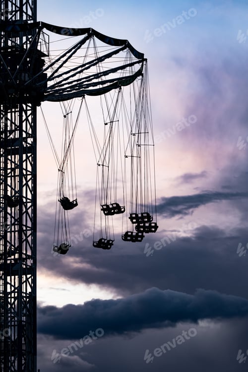 Preview: Vertical shot of a high-speed Oktoberfest carousel tower in Munich, Germany