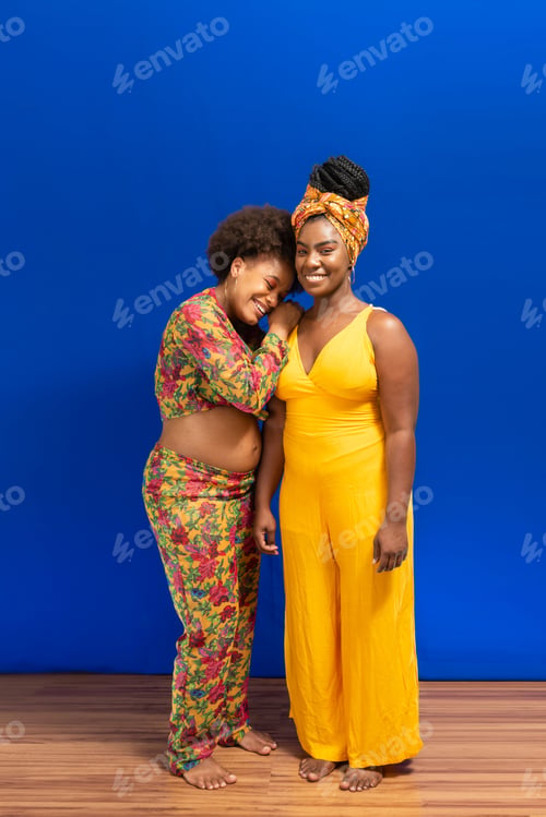 Preview: Portrait of two women against blue background.