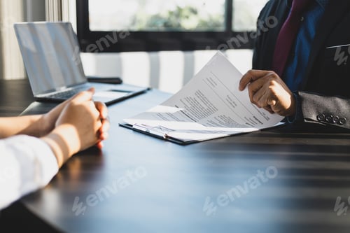 Preview: Employer in suit reading resume of job interview candidate profile collection.