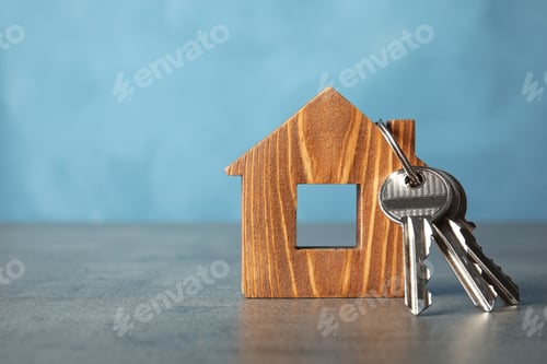 Preview: Bunch of keys and house model on table against color background. Space for text