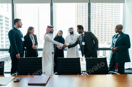 Preview: International business people shaking hands in dubai office meeting