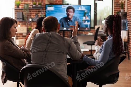 Preview: Diverse team working at company presentation discussing financial statistics