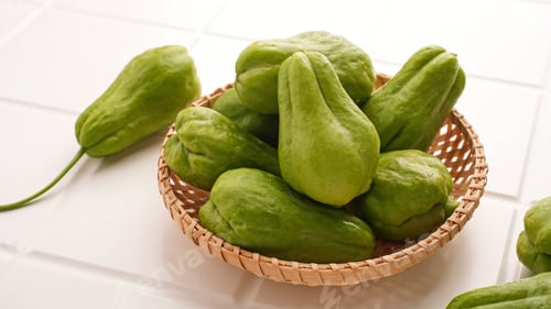 Preview: A pile of green chayote squash on bamboo plate